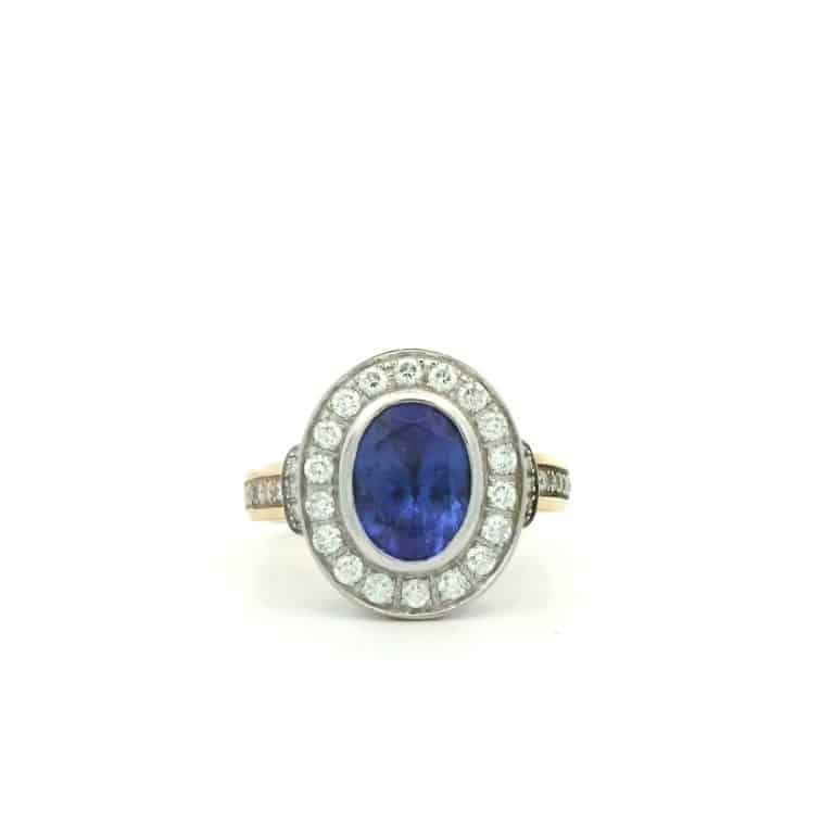 Oval blue gemstone ring with diamonds