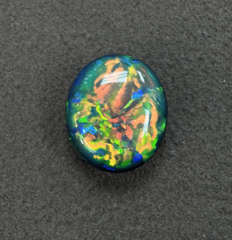 Colorful, iridescent gemstone on black