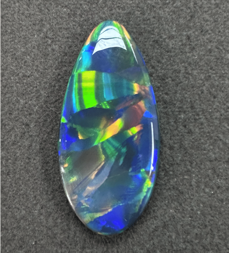 Colorful, iridescent gemstone on black